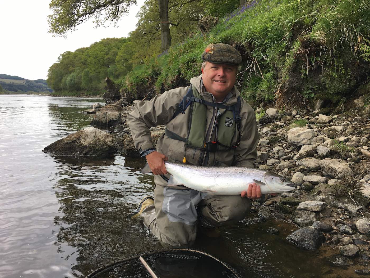 This salmon fishing tour guest keeps his lucky flies in his fishing cap as you can see here. Most of the old school Scottish salmon ghillies used to do the exact same thing. This perfect Spring salmon was caught on the River Tay near Pitlochry and I took this fine shot as his personal salmon fishing guide that day.