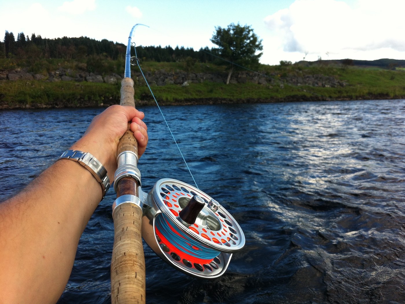 Here's the double handede salmon Spey rod being held out and high across the fast stream at the Guay Pool on the Lower Kinnaird Beat of the River Tay near Dunkeld. This method is how you control your salmon fly at long range which is a rare skill seldom understood by the majority of new salmon fishers. A professional salmon fishing guide will teach these vital fly fishing skills.