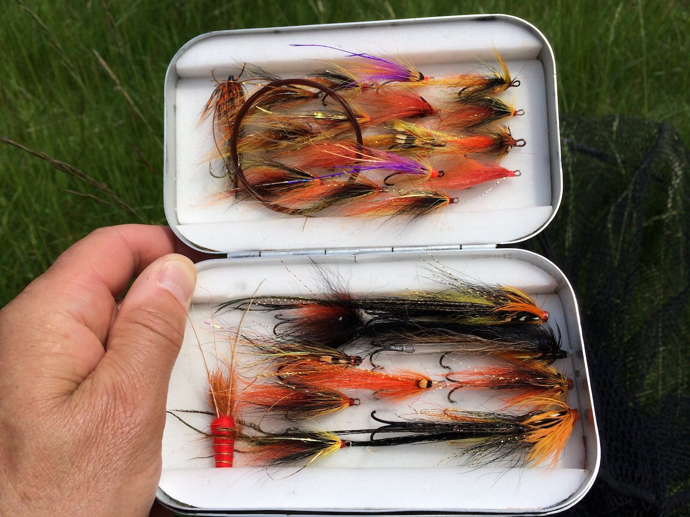 Here's one of my own Wheatley aluminium salmon fly boxes with a few choice patterns in it and a spare coiled up salmon leader. Once your salmon fly faith levels rise then you'll always know what fly to tie on during each month of the salmon fishing season.
