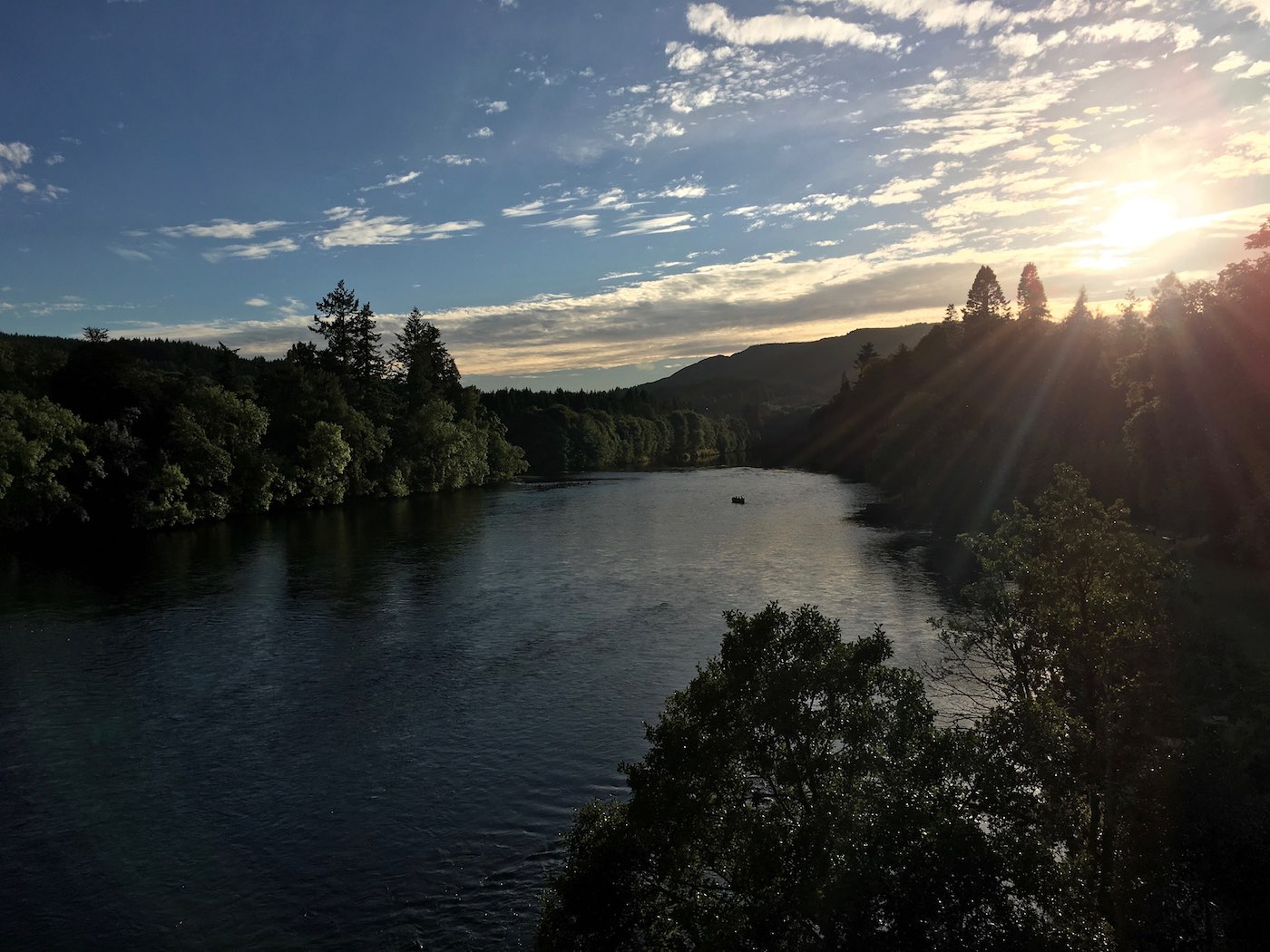 This upstream dusk shot of the Cathedral Stream was taken from the middle section of the Telford Bridge in Dunkeld. You can see the  salmon fishing guide with his fishing guest still out in the boat as the light is starting to fade in pursuit of an evening salmon.