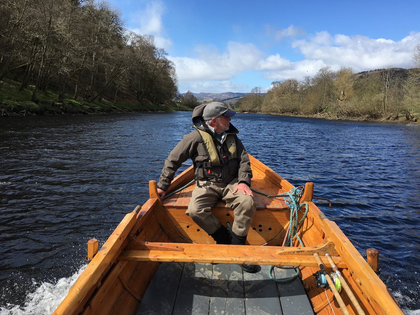 This River Tay salmon fishing guest was sitting up on the bow of the boat to assist with the navigation of the boat through some downstream shallow water. This tactic lifts the outboard engine's propeller a few inches which makes a huge difference for shallow water navigation. This is a subtle navigational trick all professional River Tay boatmen will know and deploy while navigating through shallow water.