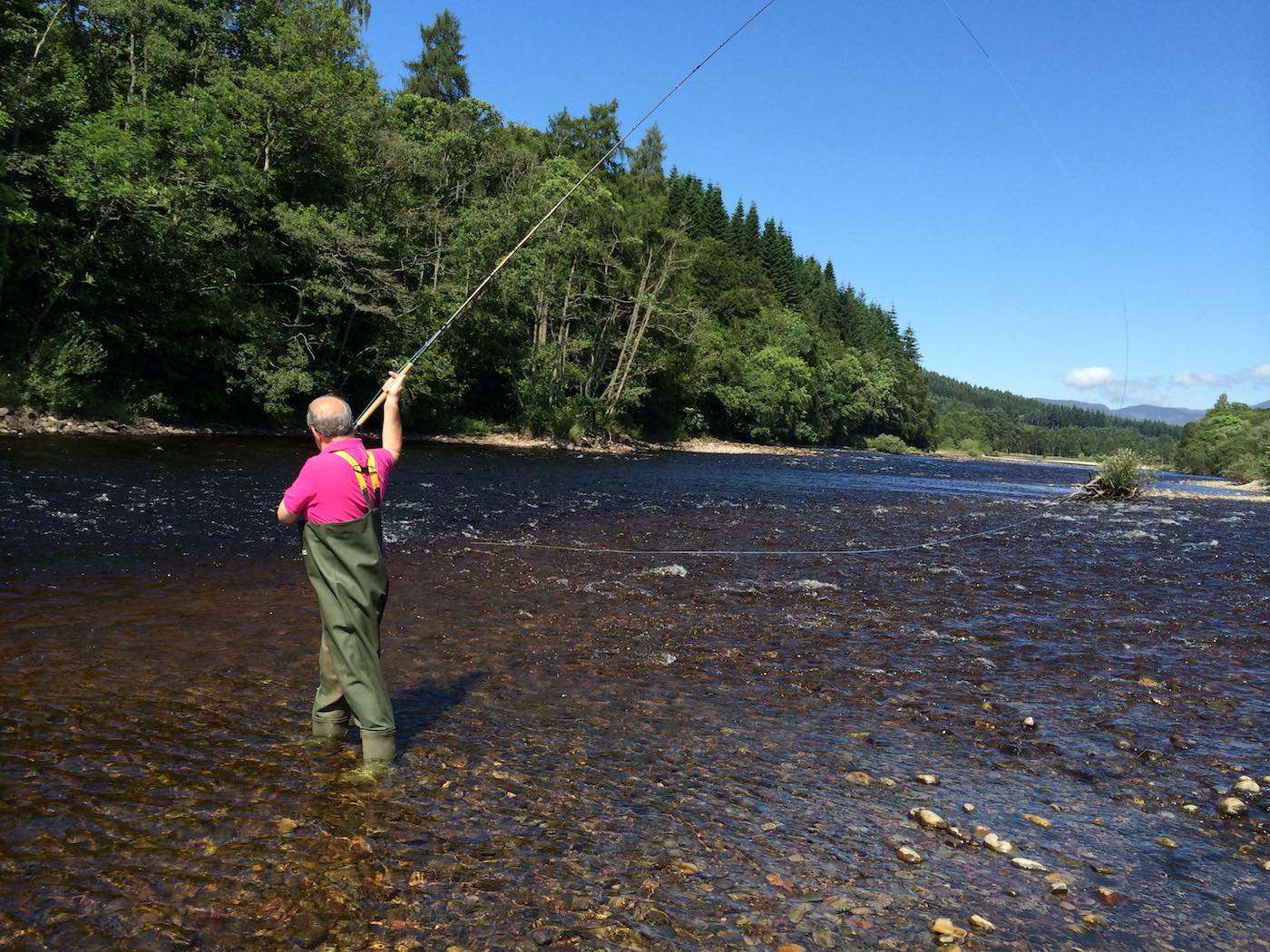 Here's a salmon fishing holiday guest in the middle of a Spey casting lesson on the River Tummel. The focus was on getting a visual of the anchor point which is the mid section of the cast where the front end of the Spey line briefly touches the surface of the river before being sent across the river. Watching this anchor point touch down assists with the timing of the power stroke as any experienced salmon fly fishing instructor will know.