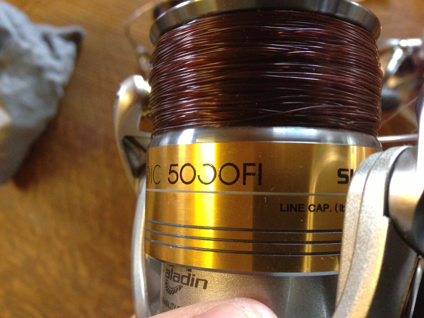 This salmon spinning reel was manufactured by Shimano and is known as a Stradic 5000. The fishing line on the spool is Maxima Chameleon in 18lbs breaking strain. I always add a few extra turns of line to the spool like you can see here just to add a bit of extra distance to each cast when working on a big wide river like the River Tay as a salmon fishing guide.