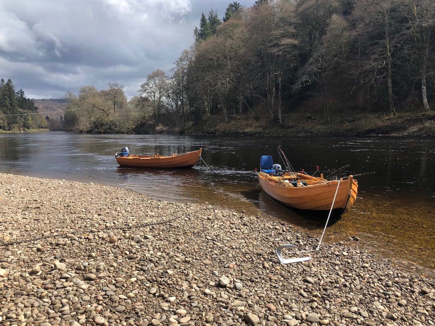 Here's a brace of these special larch & oak built River Tay salmon fishing boats. These boats are known as the 'Tay coble' and are fantastic for assisting guests to catch salmon. These have numerous fishing applications such as harling, trolling, anchored up fishing which can often provide a salmon fishing advantage. You can see the long rope and anchor in addition to the blue padded comfortable boat seats.