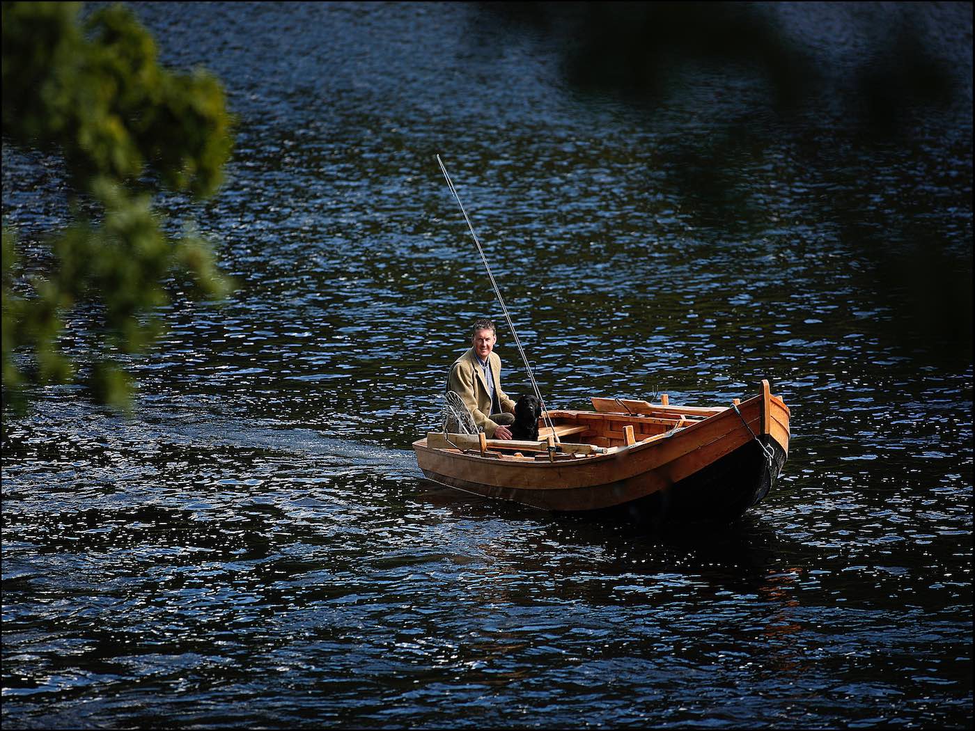 Here's Jock Monteith out in a traditional River Tay salmon boat in the Cottar Pool of the Newtyle Beat. This lovely shot was captured by top Scottish photographer Peter Sandground during late Spring. You can see 'Selkie' Jock's black labrador dog at the bow of the boat.