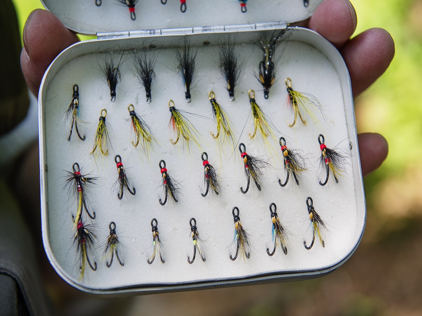 Sometimes in low warm water Summer fishing conditions it can be an effective strategy to use very small lightly dressed salmon flies like the ones in this picture. It often amazes me as to how small a fly a salmon will come for and sometimes even in higher water conditions too! This fly box was photographed on the River Tay at Dunkeld by Peter Sandground who's one of Scotland's leading photographers.