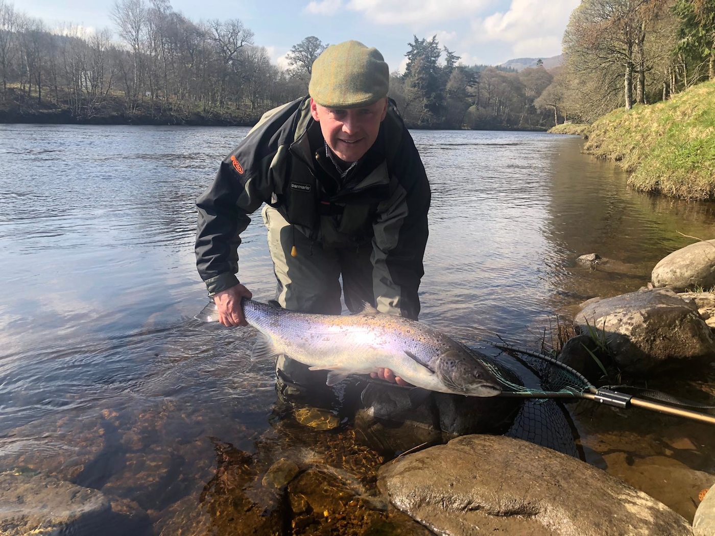 This perfect 22lbs Spring salmon was caught by River Tay salmon guide team member Kevin Mckay near Dunkeld during early March. You can see Kevin is wrapped up warmly with his Harris tweed cap on to combat the cooler Spring weather in Scotland. This salmon was caught in the Gauge Tree Pool where many of our salmon fishing holiday clients are taken to fish each year.