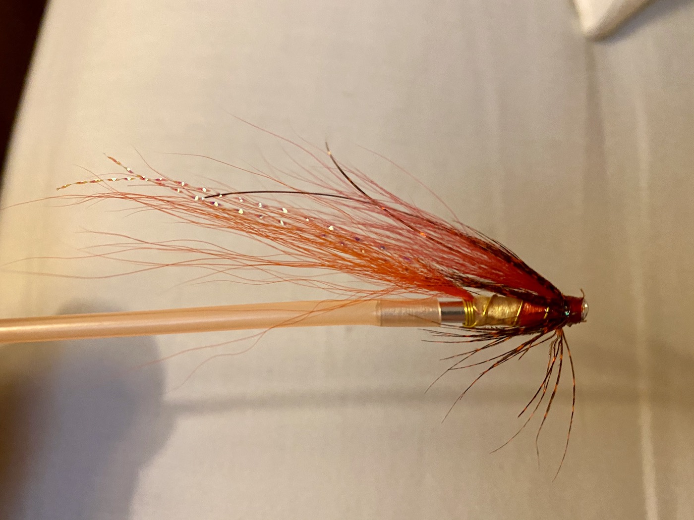 If you get rid of the soft rubber sleeves that most tube flies come with and replace them with rigid plastic sleeves they will result in more solid hook sets as the hard version don't pivot and keep the hoof straight while being set by the angler. It's fairly tricky to fit a hard plastic sleeve but some patience and a bit of heat will do the job. This is a Jock's Shrimp tube fly which I tied on a copper tube fly body.