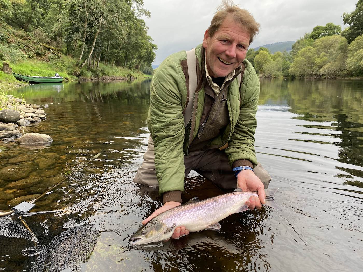 Here's professional River Dee salmon guide John Fyfe holding 1 or 3 salmon that he landed on the River Tay near Dunkeld during the month of August. I personally guided him this day to eliminate him guessing where the salmon were holding and his professional salmon fishing presentation expertise did the rest. This Summer salmon was landed at the Green Bank Pool on the Kinnaird beat and you can see the Tay salmon boat in the background.