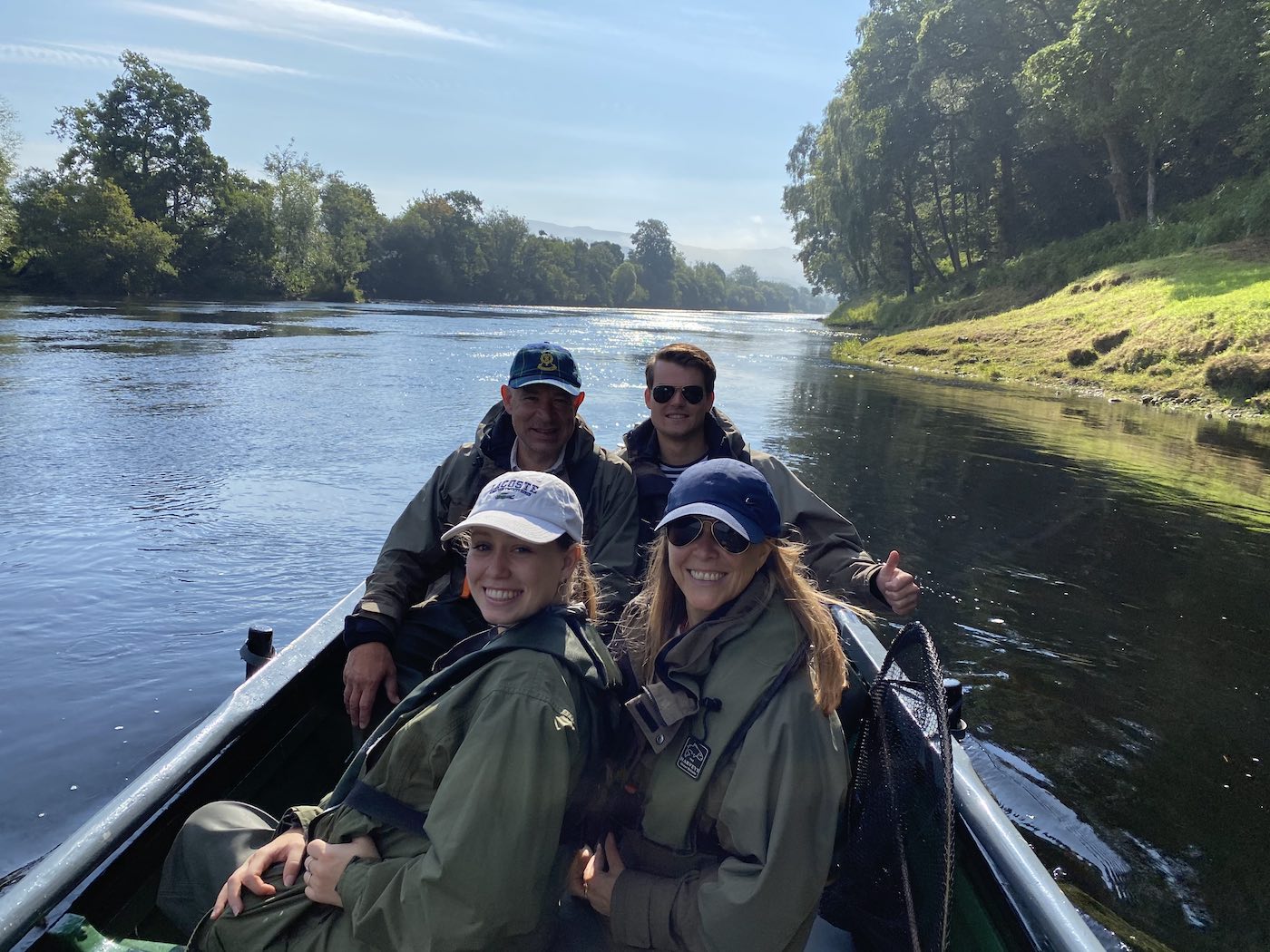 This family fishing party came to the Tay for an introduction to Scottish salmon fishing during July. The young lady with the white cap landed her first ever fly caught salmon that day much to the amazement of her onlooking family members. Look at the perfectly cut riverbank to the right hand side of the traditional Tay salmon fishing boat.