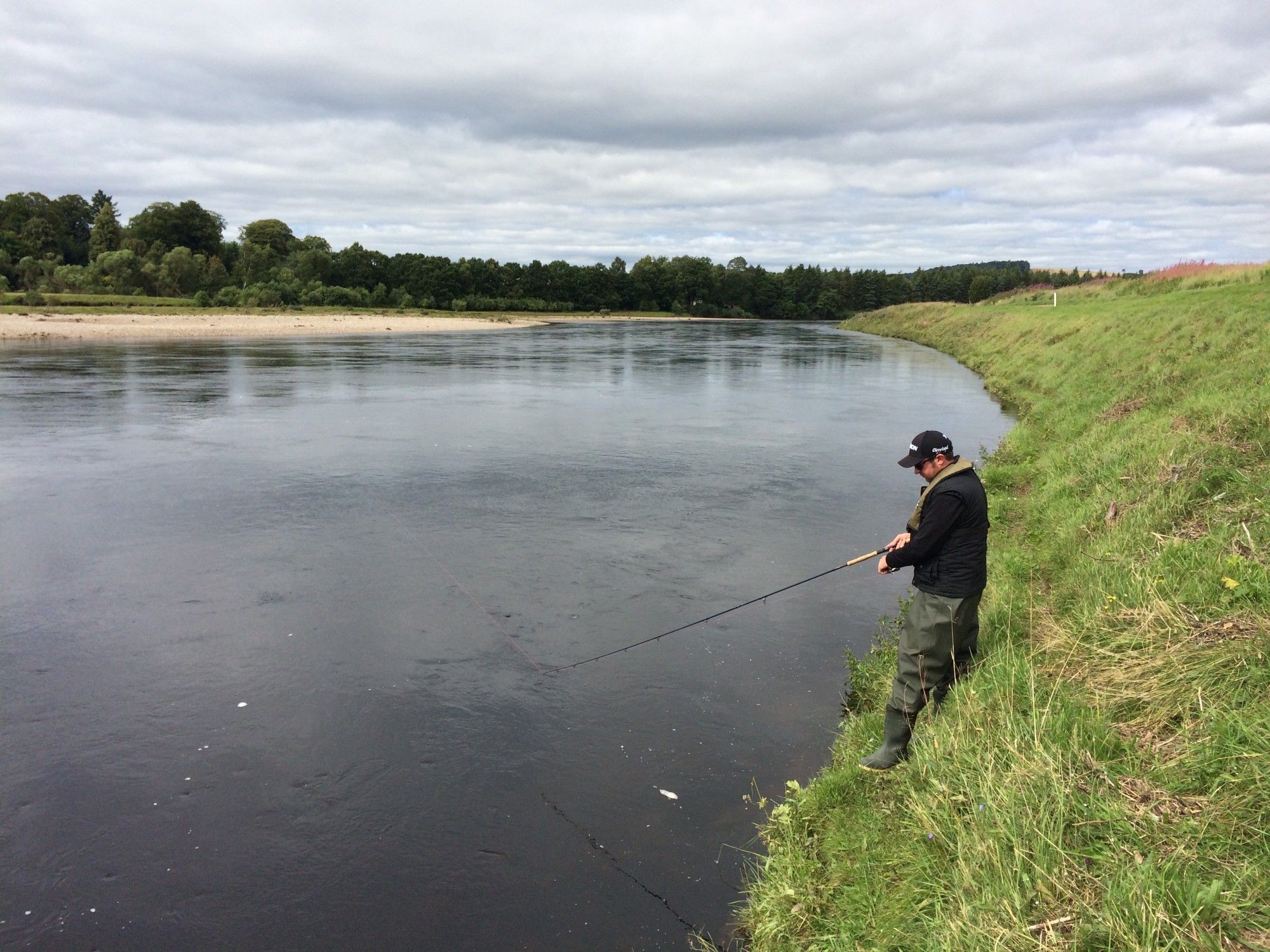 Here's an angler spinning a fishing lure through the Kercock beat's main Gean Tree salmon pool during late morning in mid Summer. This salmon fishing guest was spin fishing from this steeper side of the river with an ABU Toby Salmo 30g in silver & copper lure.
